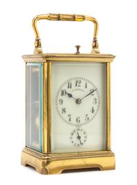 A French Gilt Brass Carriage Alarm Clock Height 6 3/4 inches. — RETAILED BY J.E. CALDWELL & CO., FIRST HALF 20TH CENTURY