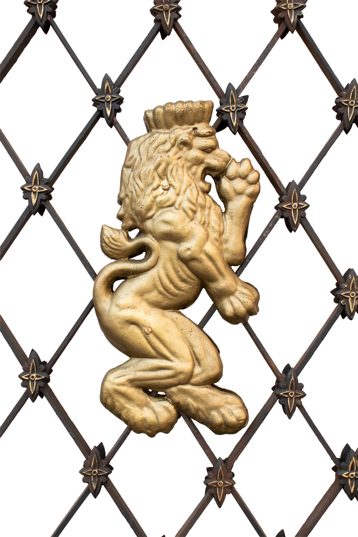 A Pair of Gates with Gilt Rampant Lion Ornaments