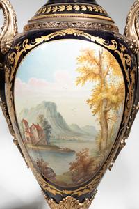 A Pair of Monumental Sèvres Style Gilt Metal Mounted Porcelain Covered Urns on Pedestals