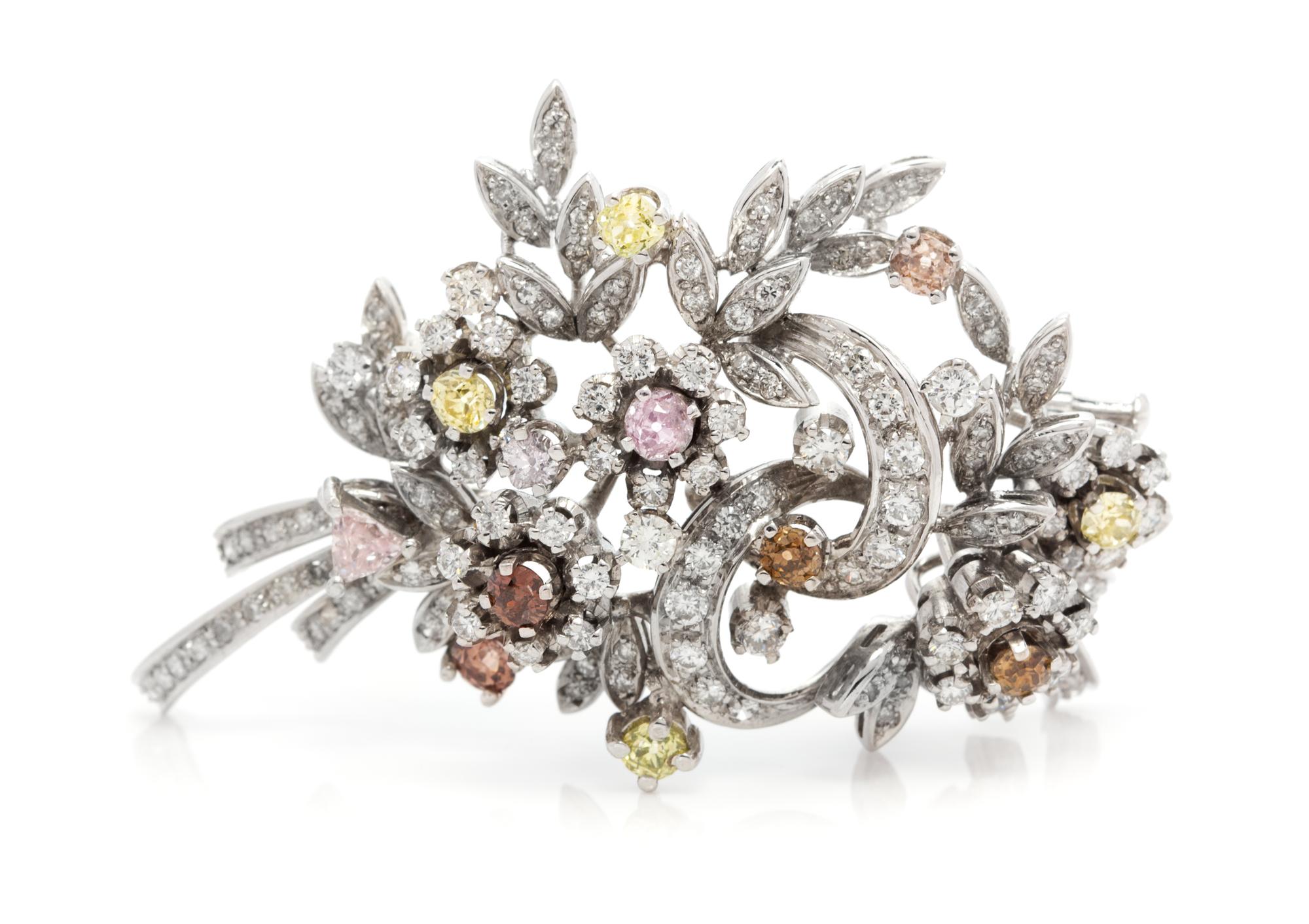 An 18 Karat White Gold, Colored Diamond and Diamond Floral Spray Brooch, 14.70 dwts.