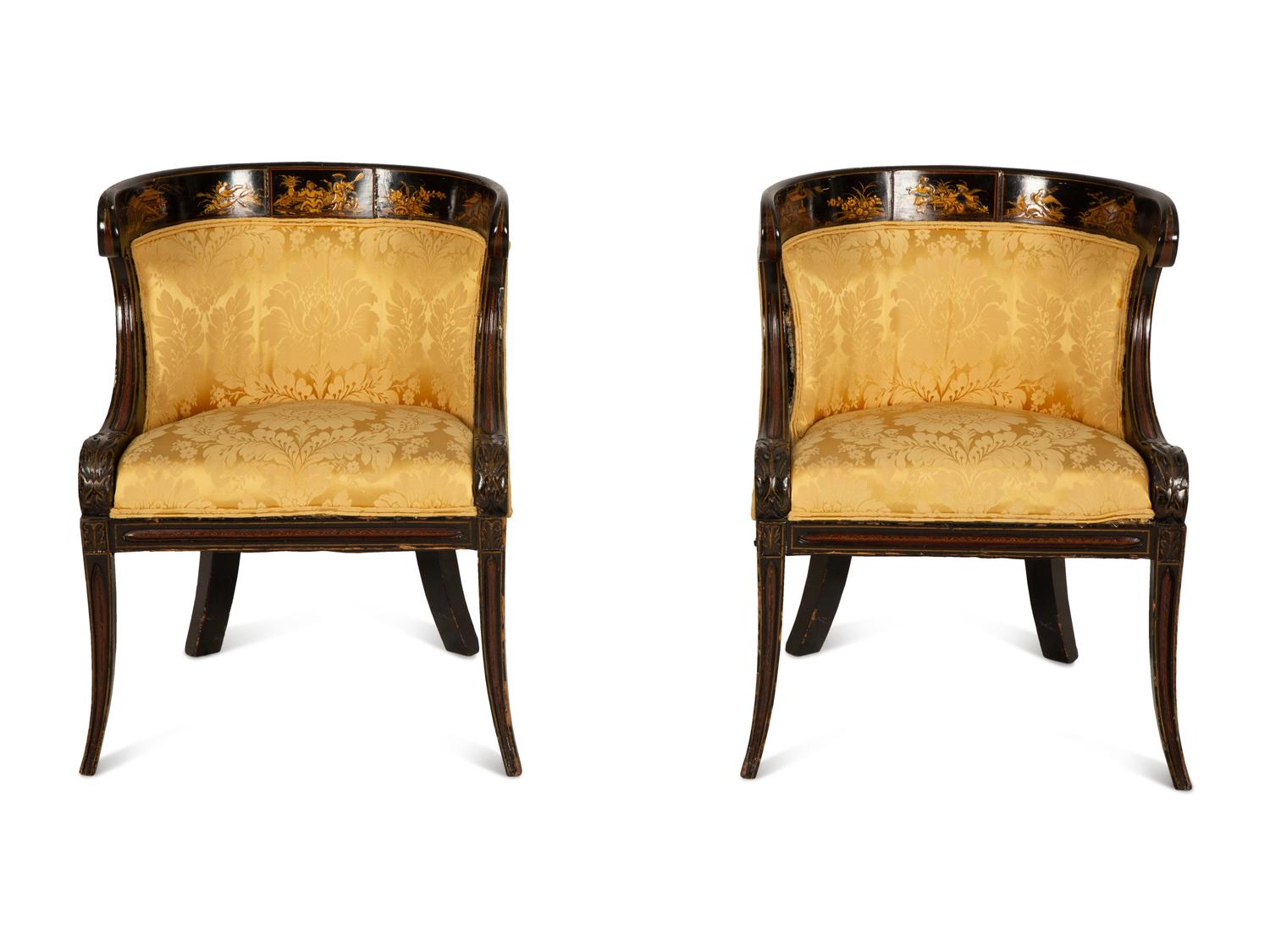 A Pair of Regency Ebonized and Gilt Barrel Back Armchairs