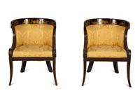 A Pair of Regency Ebonized and Gilt Barrel Back Armchairs