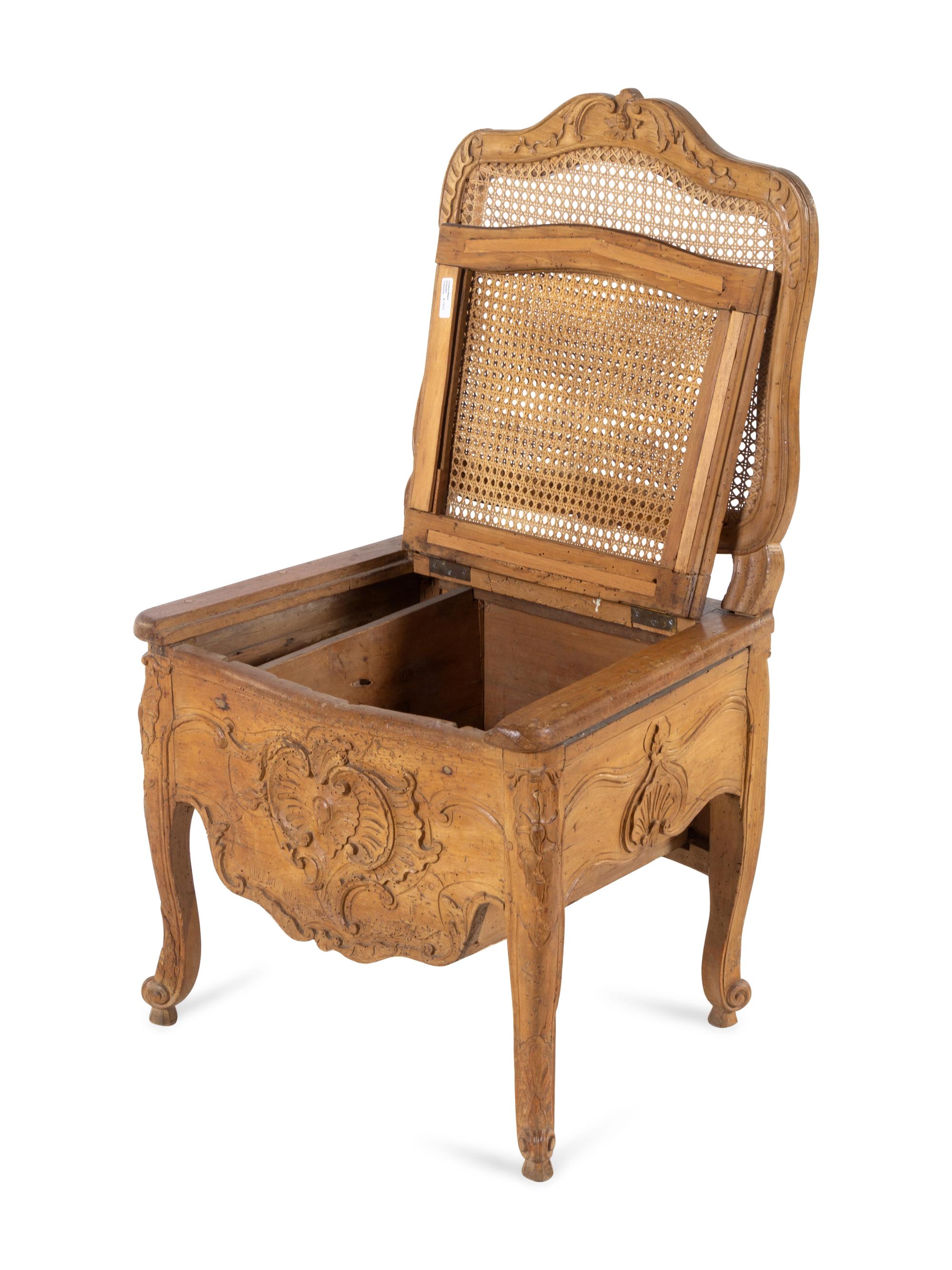 A Louis XV Provincial Carved Fruitwood Commode Chair
