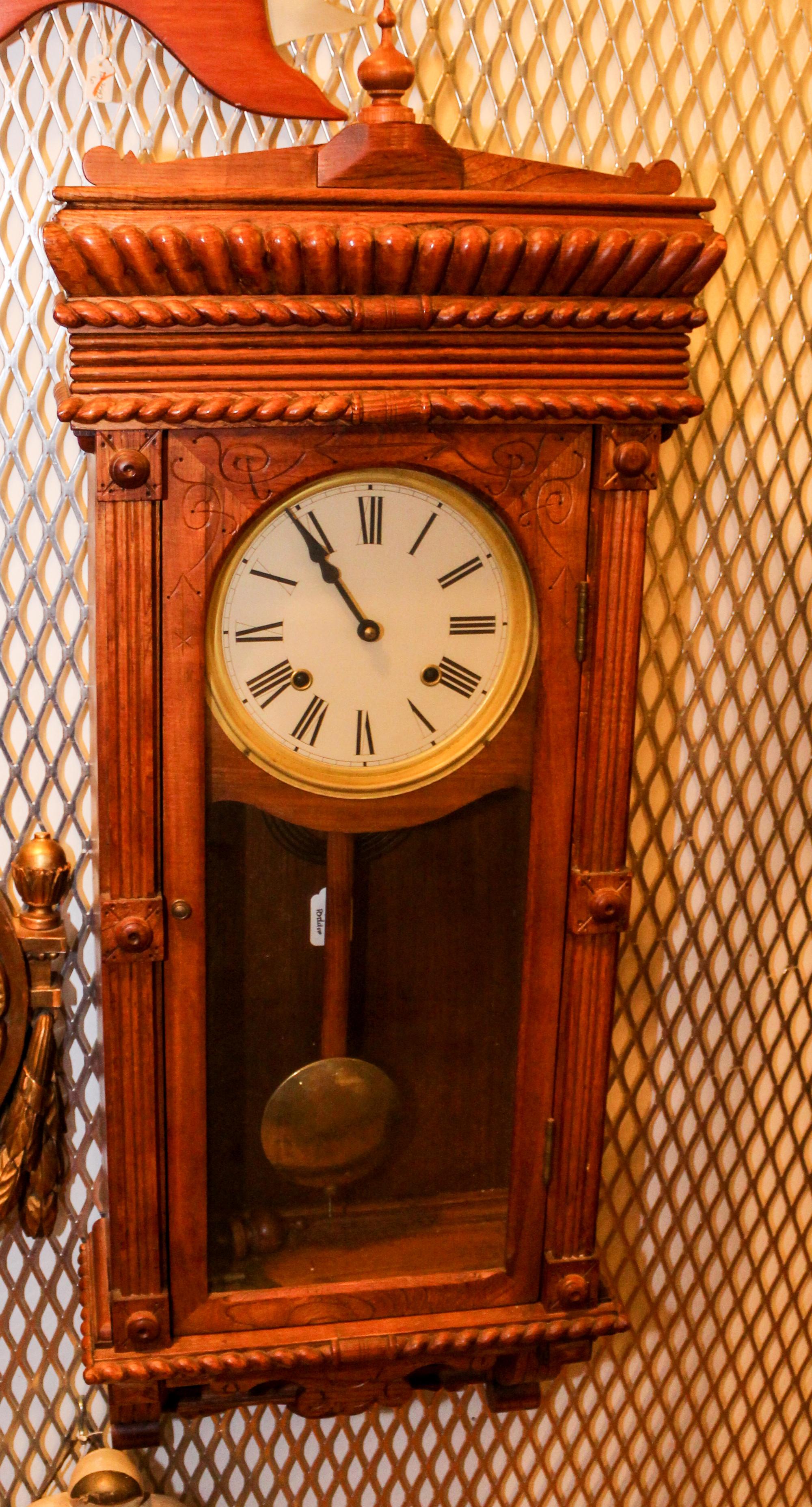 A Late Victorian Carved Oak Wall Clock. Height 38 inches.