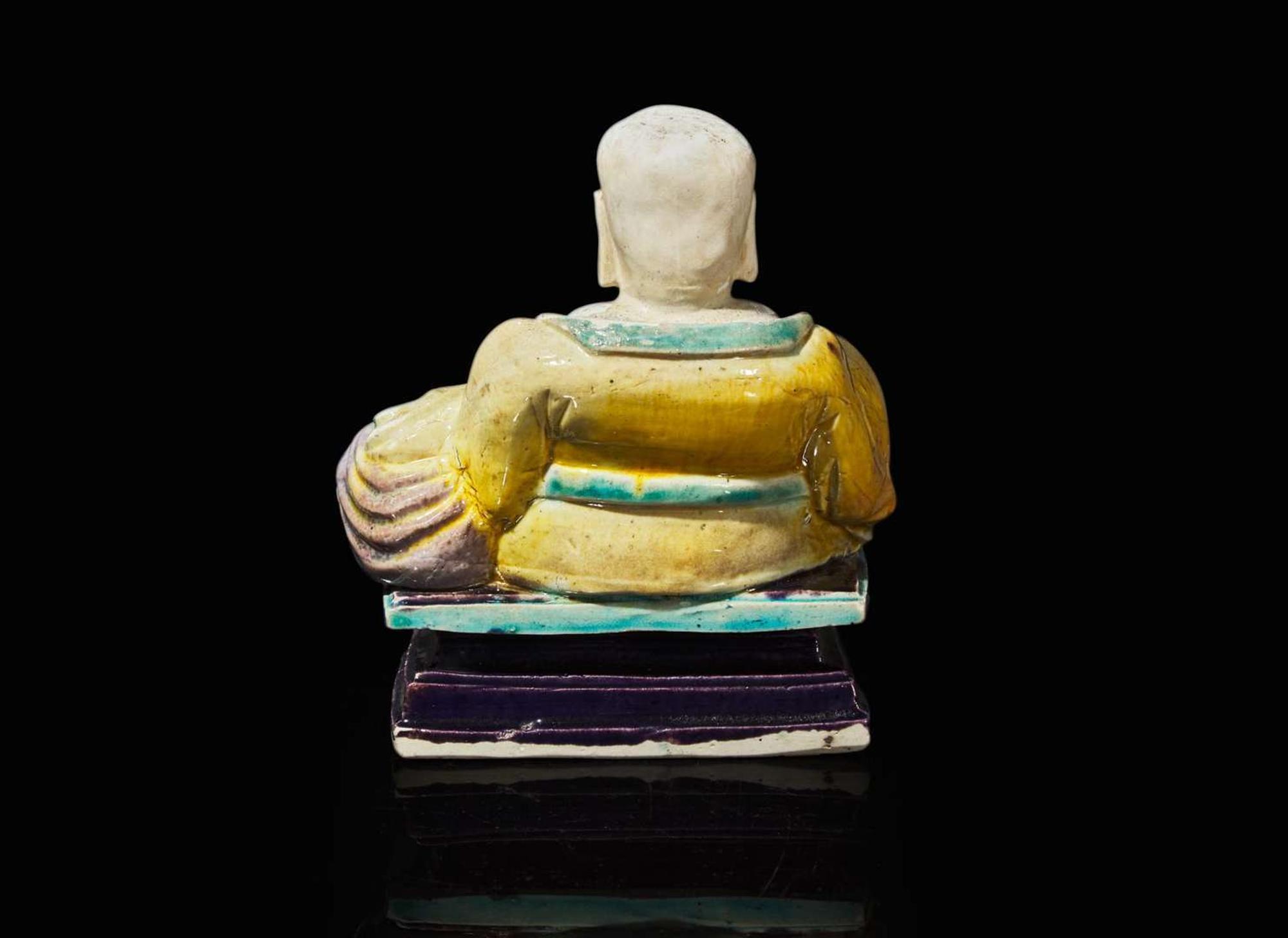 A Chinese glazed biscuit figure of Budai, Kangxi period 素三彩佈袋和尚 清康熙