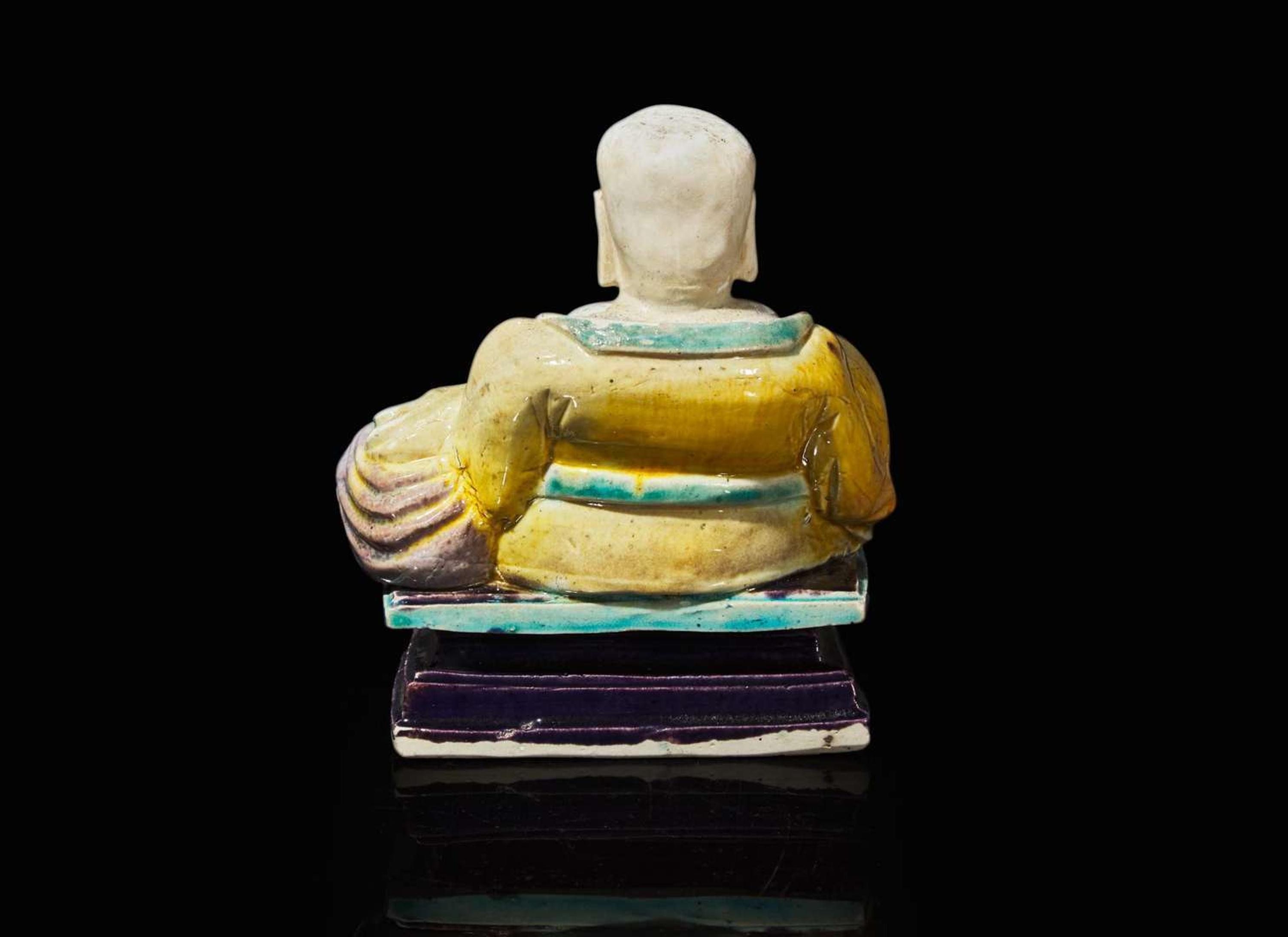 A Chinese glazed biscuit figure of Budai, Kangxi period 素三彩佈袋和尚 清康熙