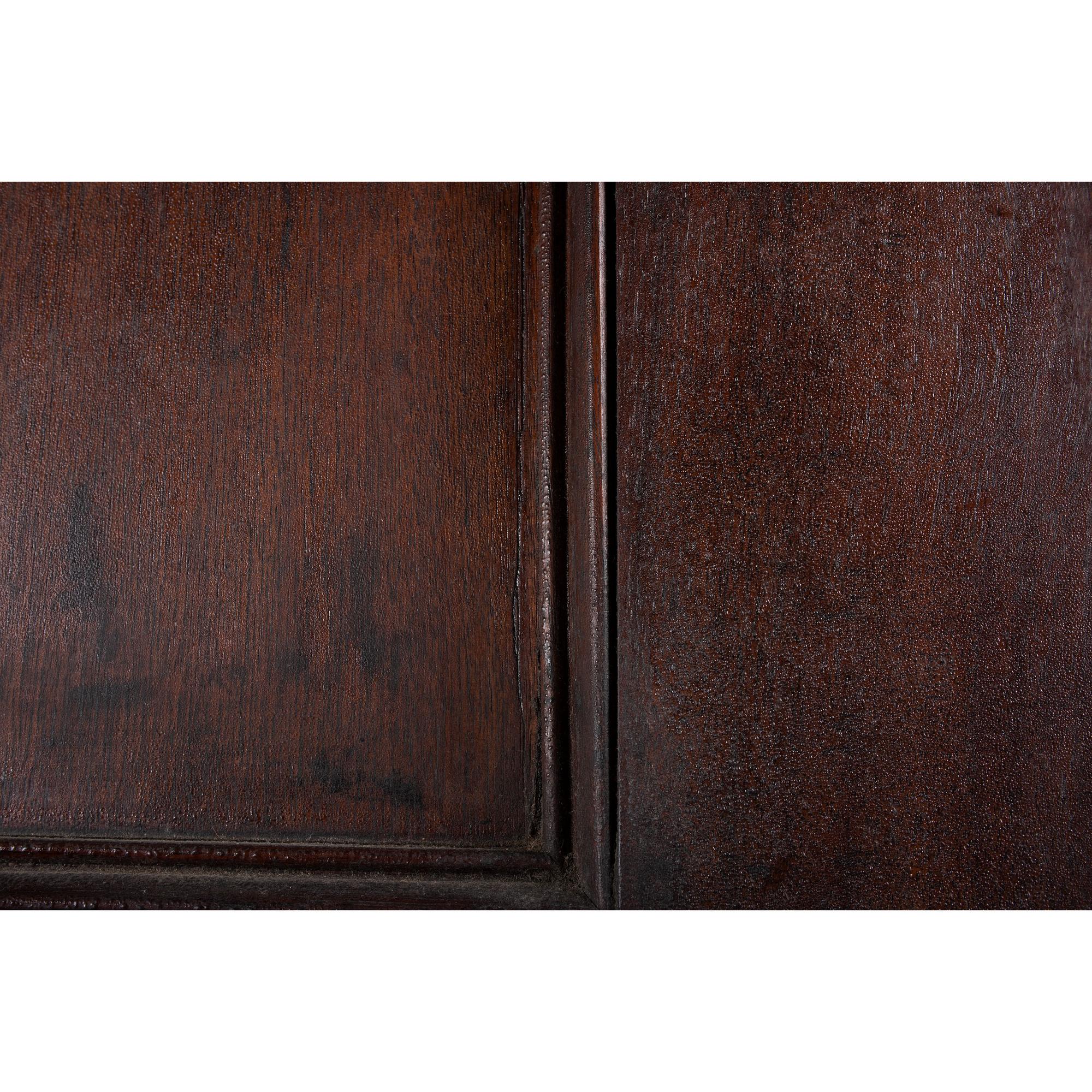 A Chippendale Style Walnut Paneled Step Back Cupboard
