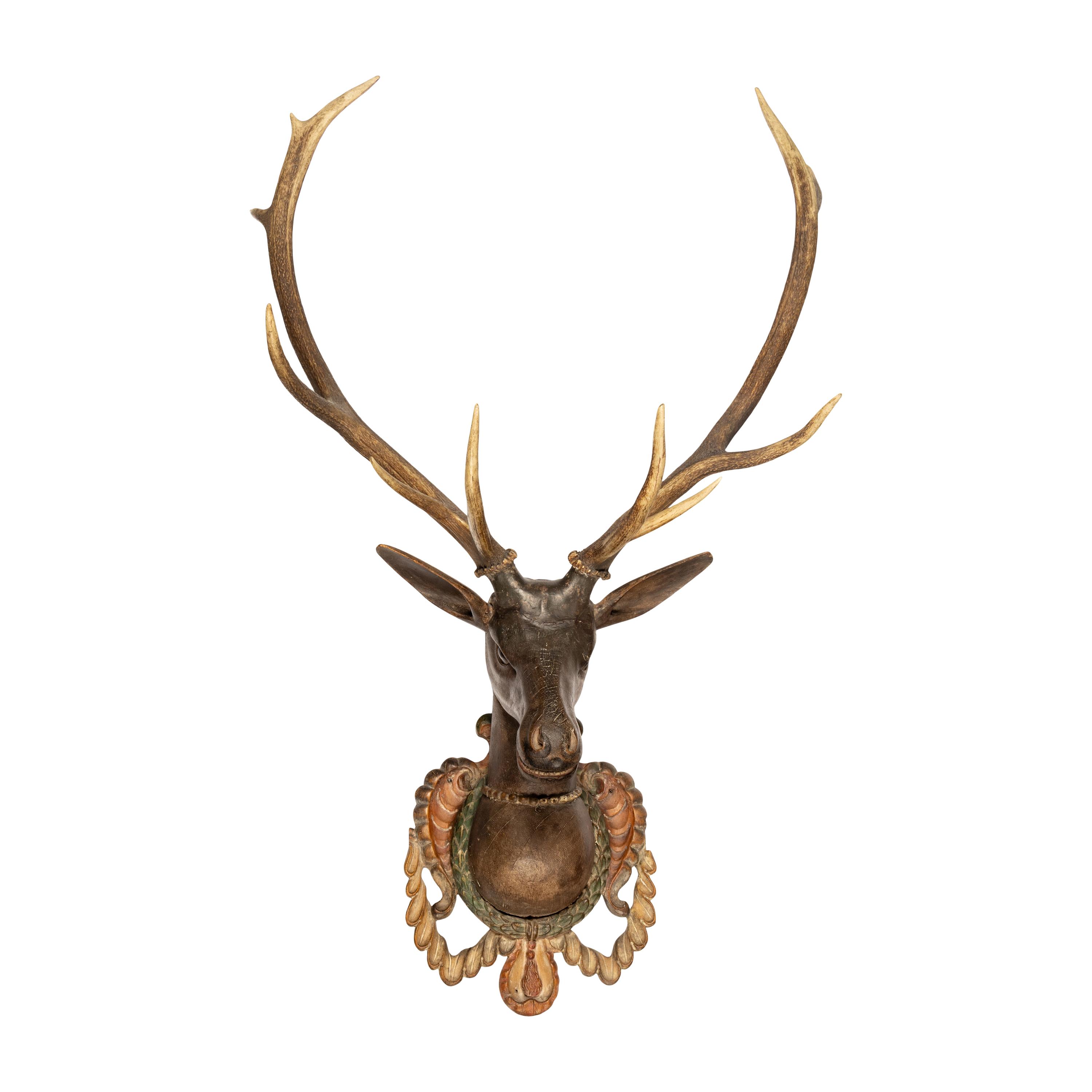A Carved and Painted Wood and Deer Antler Mount