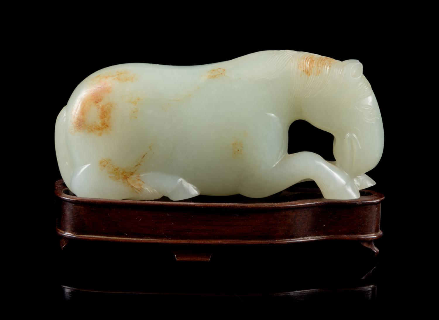 A Carved White Jade Figure of a Horse Length 3 3/4 inches. — 19TH CENTURY