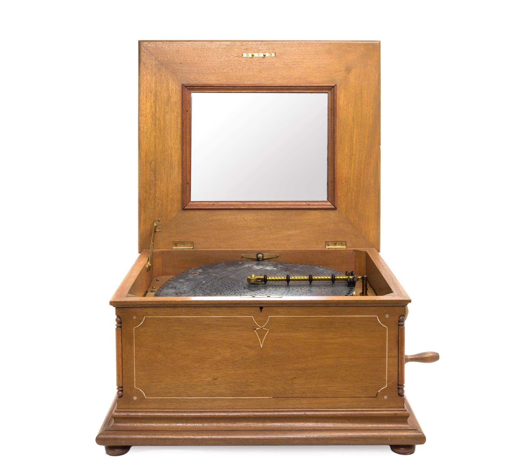 A Regina Disk Music Box, Height 12 1/2 x width 21 1/8 x depth 18 5/8 inches.