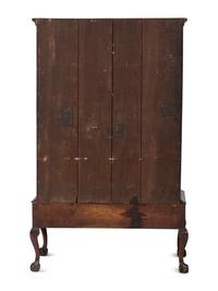 A Chippendale Carved and Figured Walnut Chest on Claw-and-Ball Foot Stand