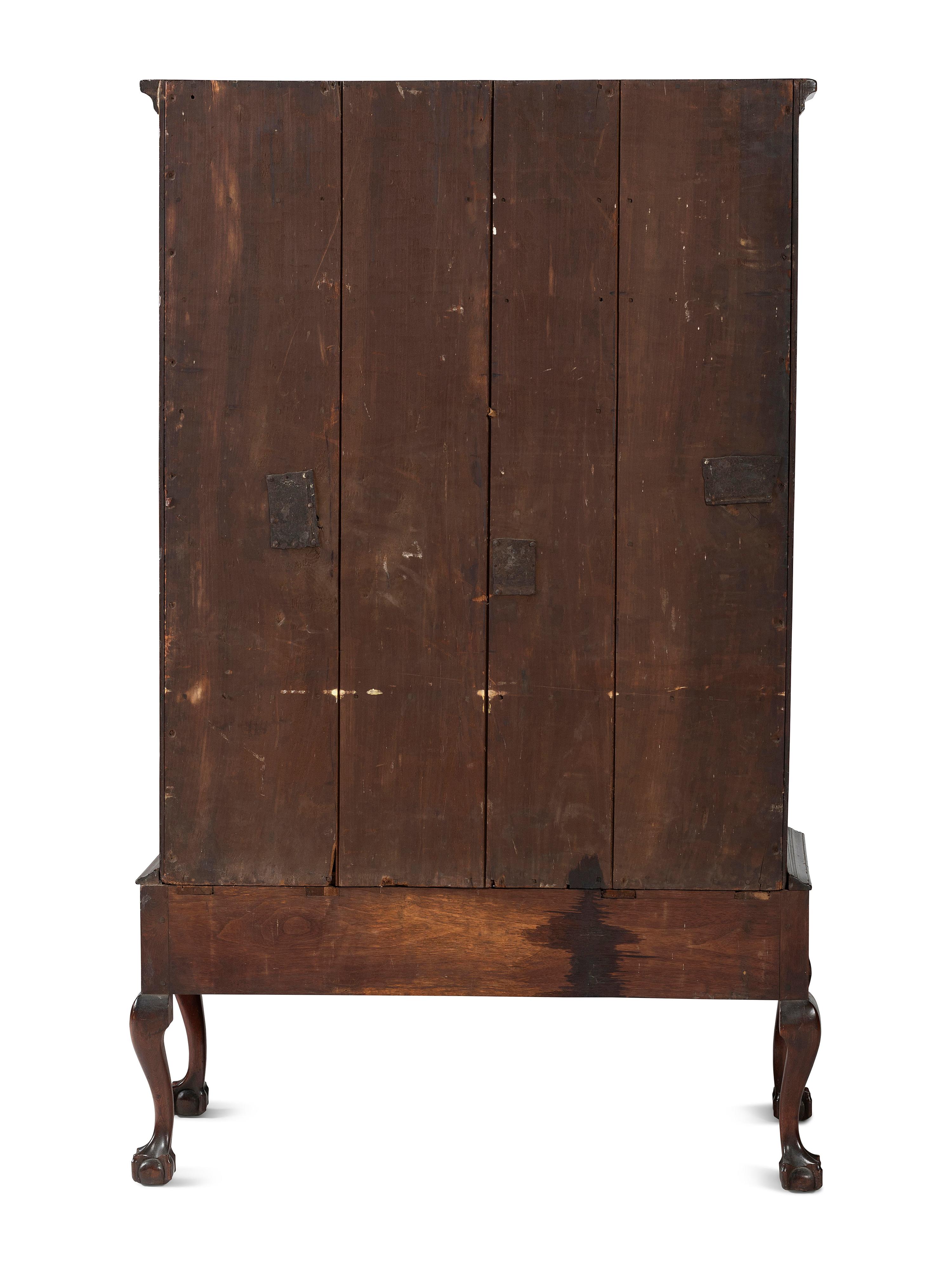 A Chippendale Carved and Figured Walnut Chest on Claw-and-Ball Foot Stand