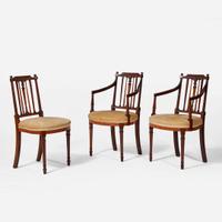 A group of three George III inlaid mahogany and satinwood dining chairs circa 1790