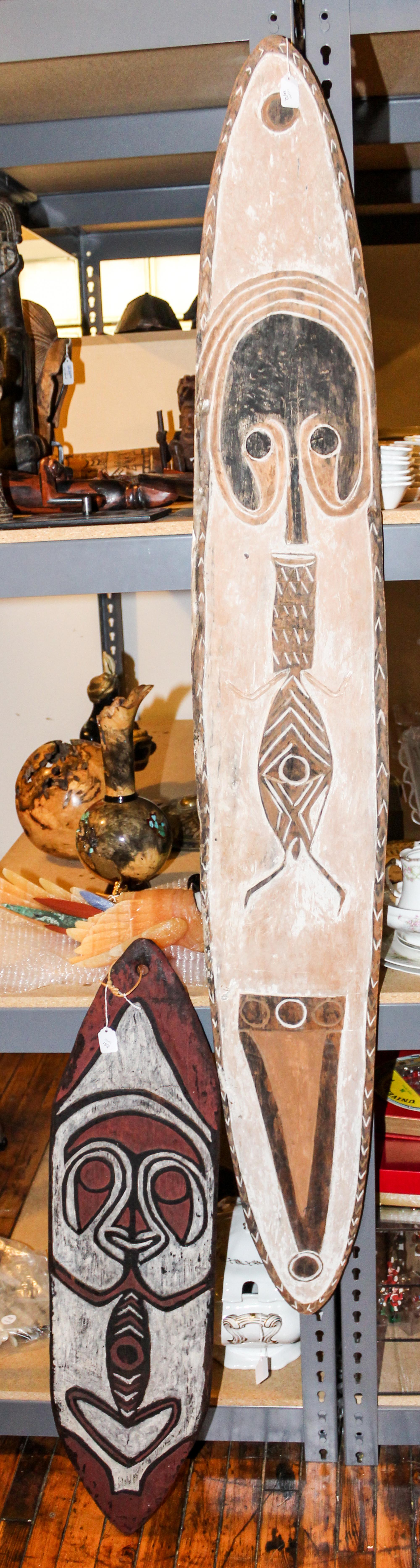 Two Polychrome Decorated Shields, New Guinea. Length of longest 67 inches.