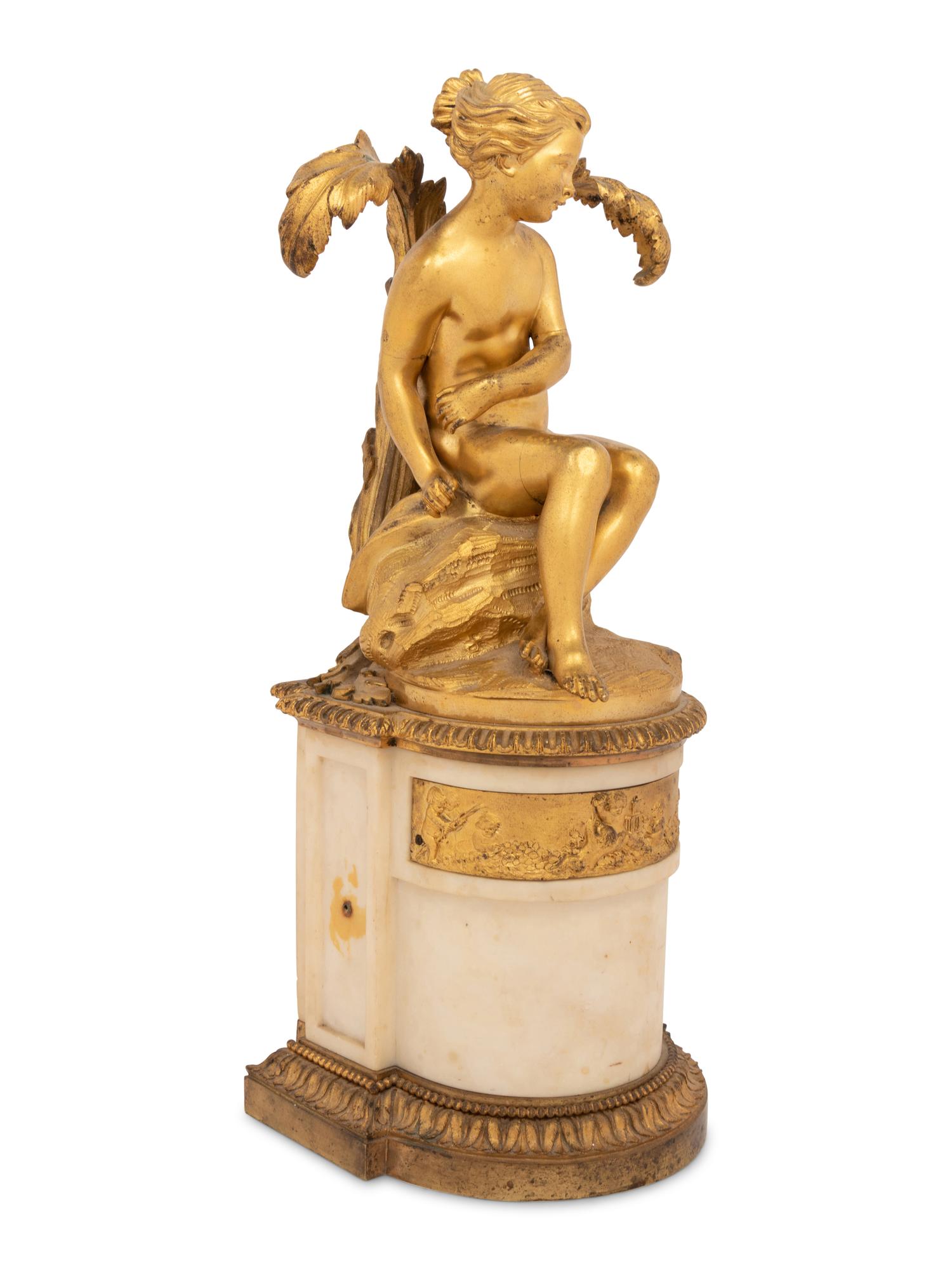 A Continental Gilt Bronze and Marble Figural Ornament