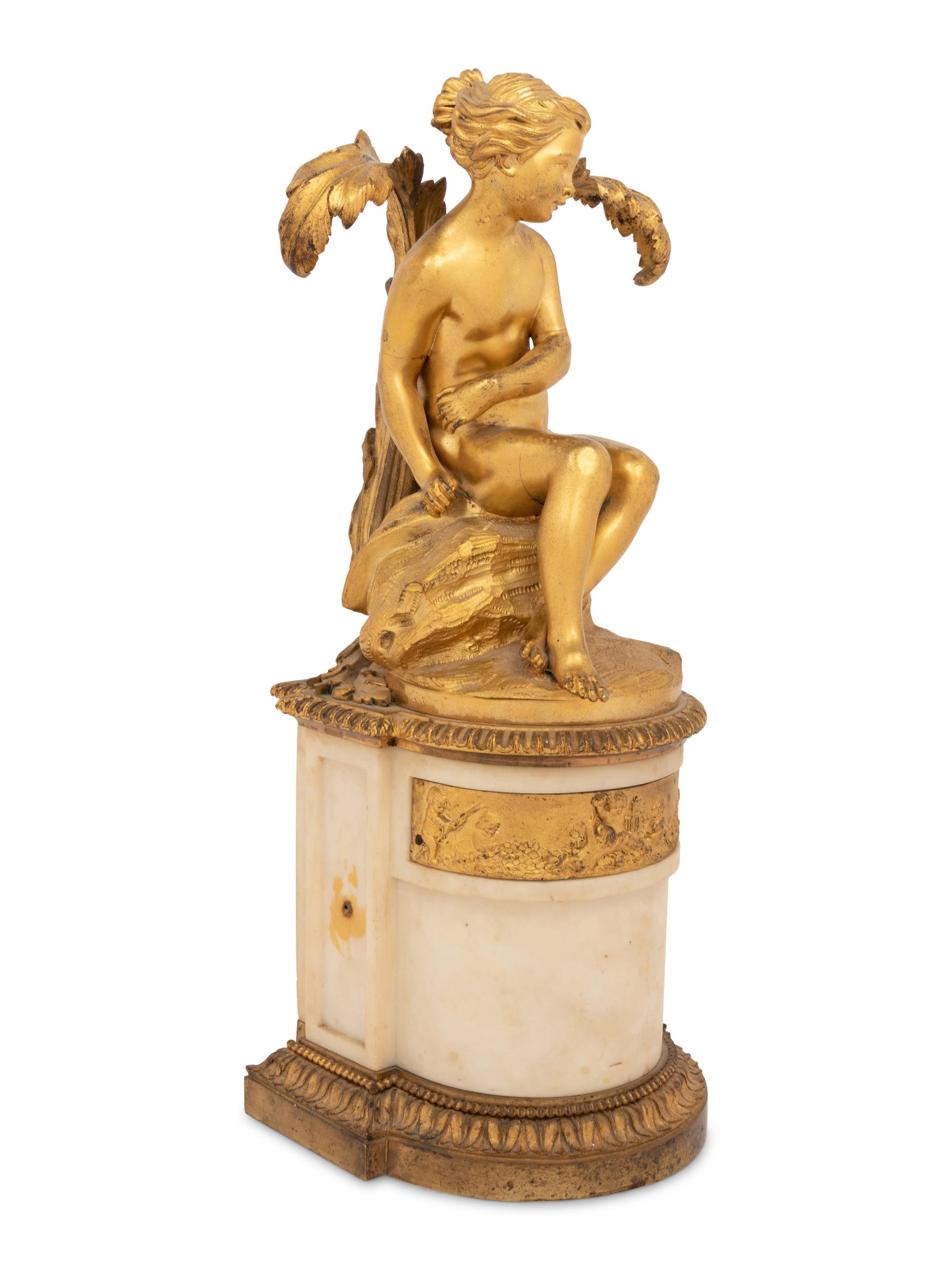 A Continental Gilt Bronze and Marble Figural Ornament