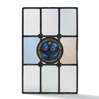 Window with cast metal lamp in circular medallion