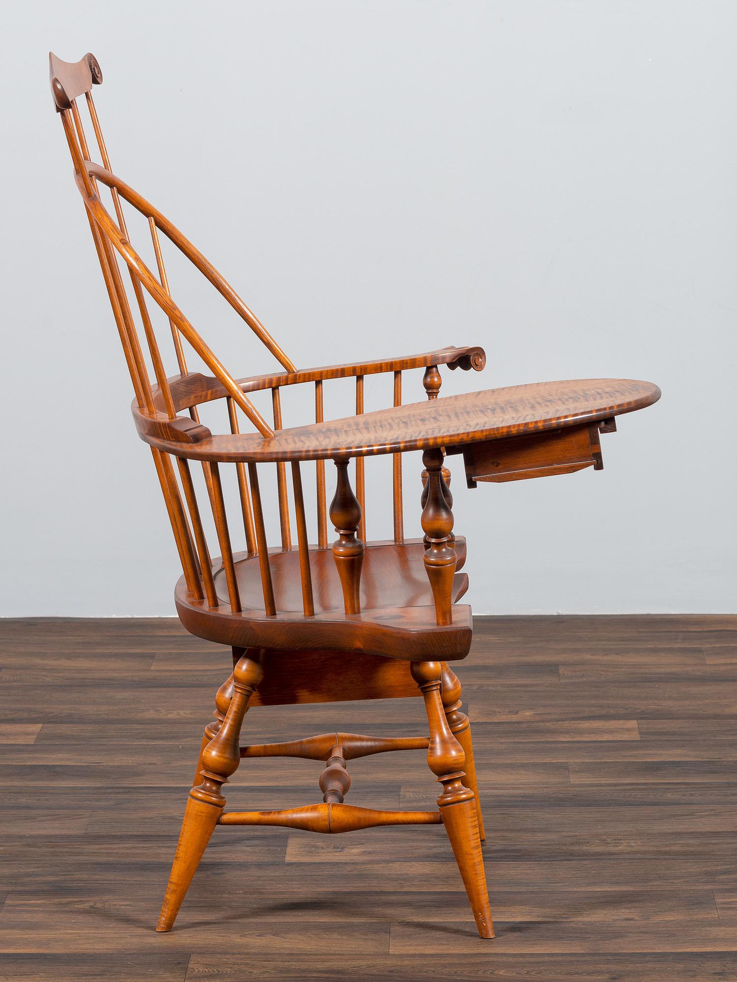 A D.R. Dimes Turned and Volute Carved Tiger Maple Windsor Three-Back Writing Armchair