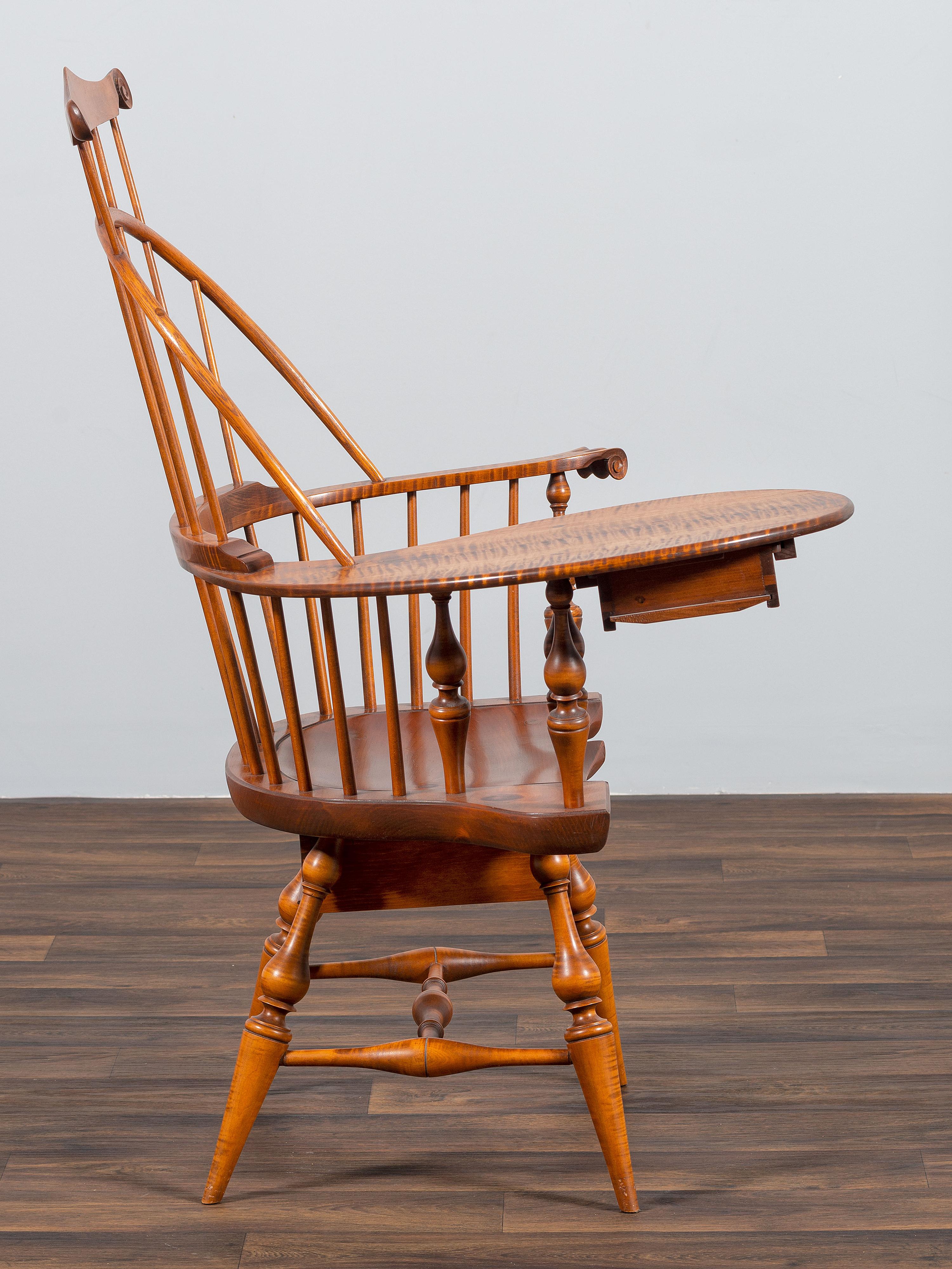A D.R. Dimes Turned and Volute Carved Tiger Maple Windsor Three-Back Writing Armchair