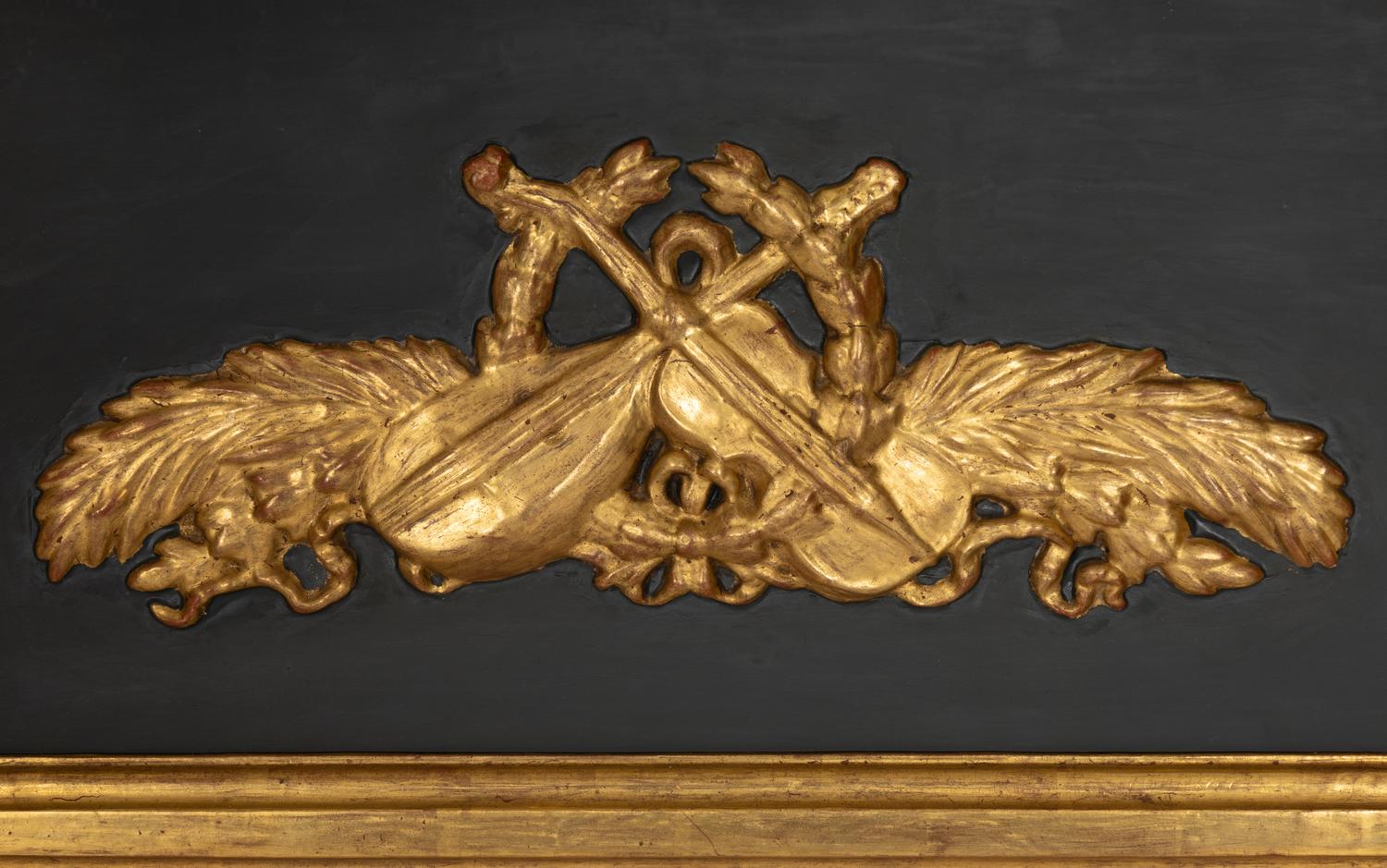 A Directoire Parcel Ebonized Giltwood Trumeau Mirror