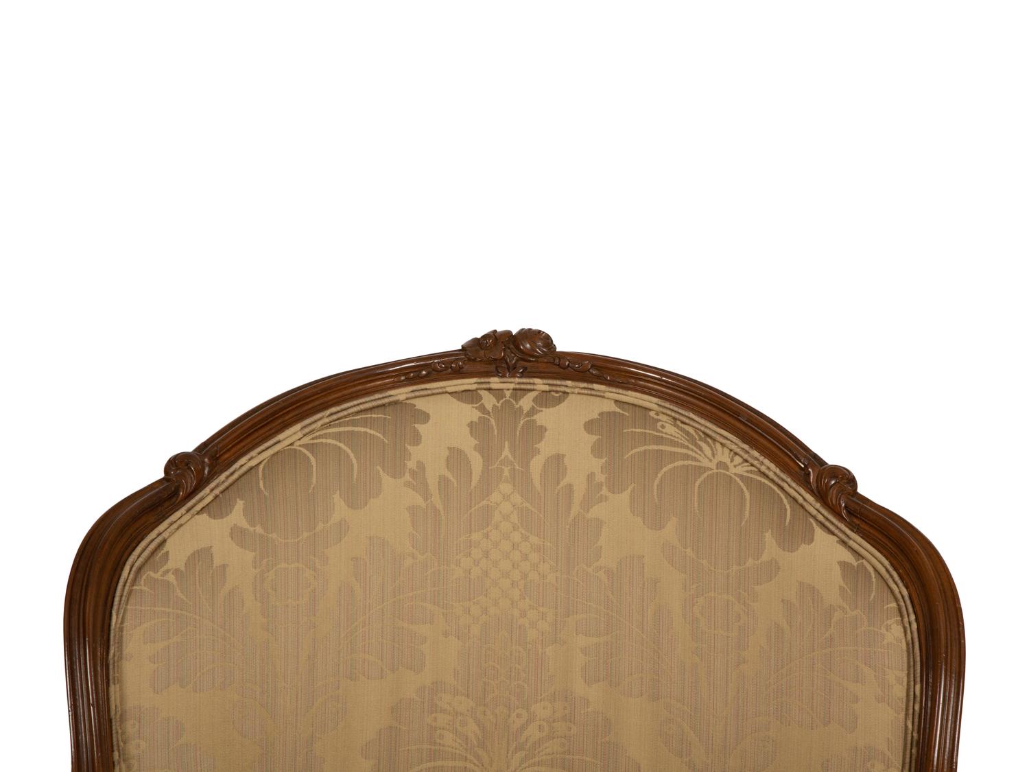 A Louis XV Style Carved Walnut Bergère