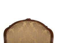 A Louis XV Style Carved Walnut Bergère