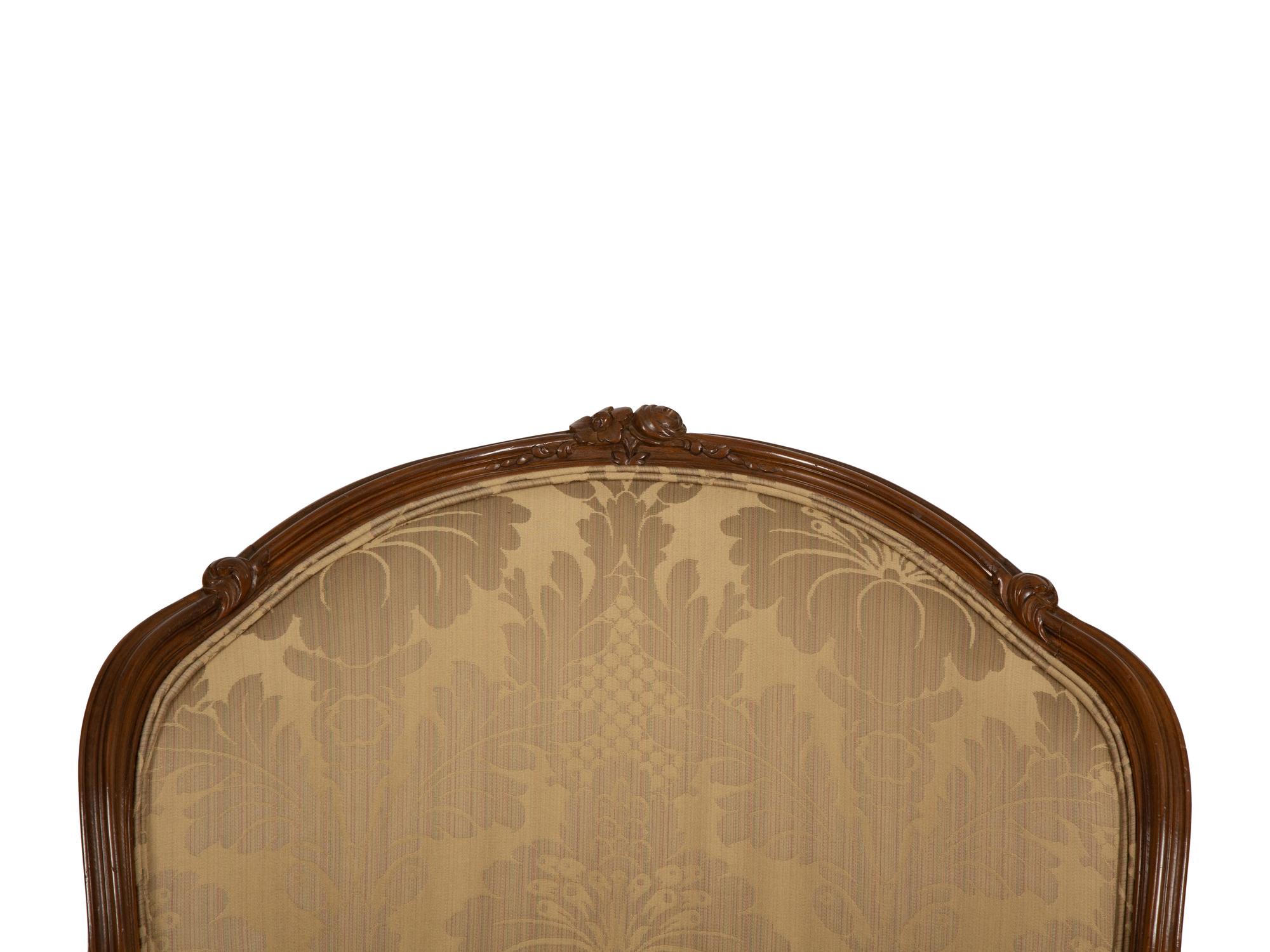 A Louis XV Style Carved Walnut Bergère