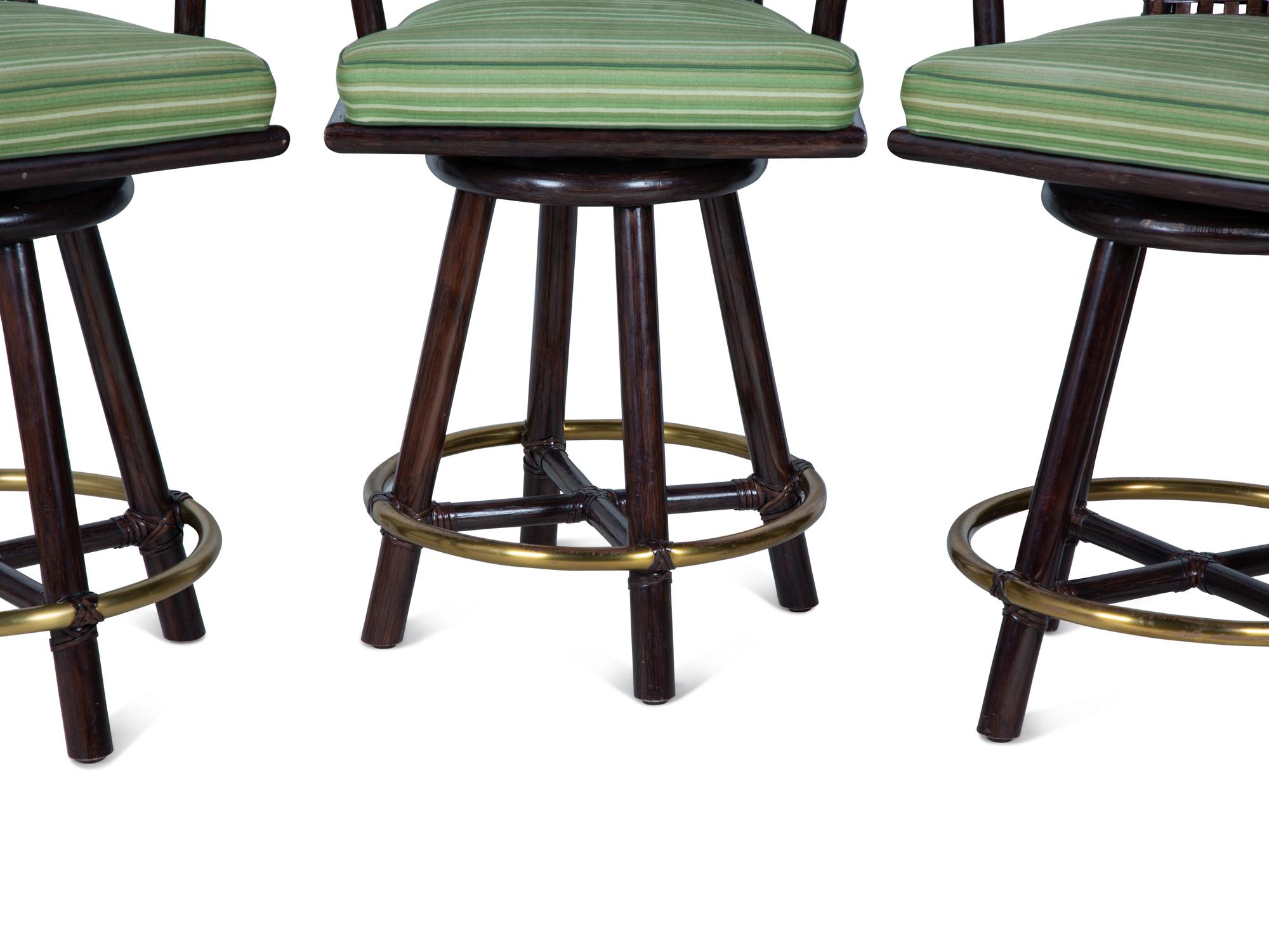 A Set of Three Stained Wood, Leather and Brass Bar Stools — 20TH CENTURY