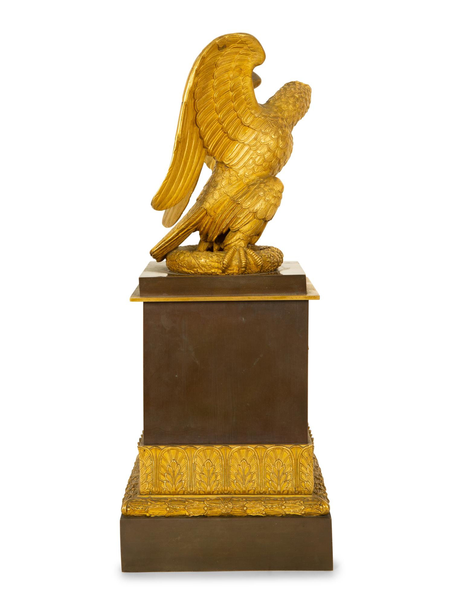 A Gilt Bronze Eagle Sculpture on an Empire Style Gilt and Patinated Bronze Base