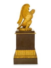 A Gilt Bronze Eagle Sculpture on an Empire Style Gilt and Patinated Bronze Base