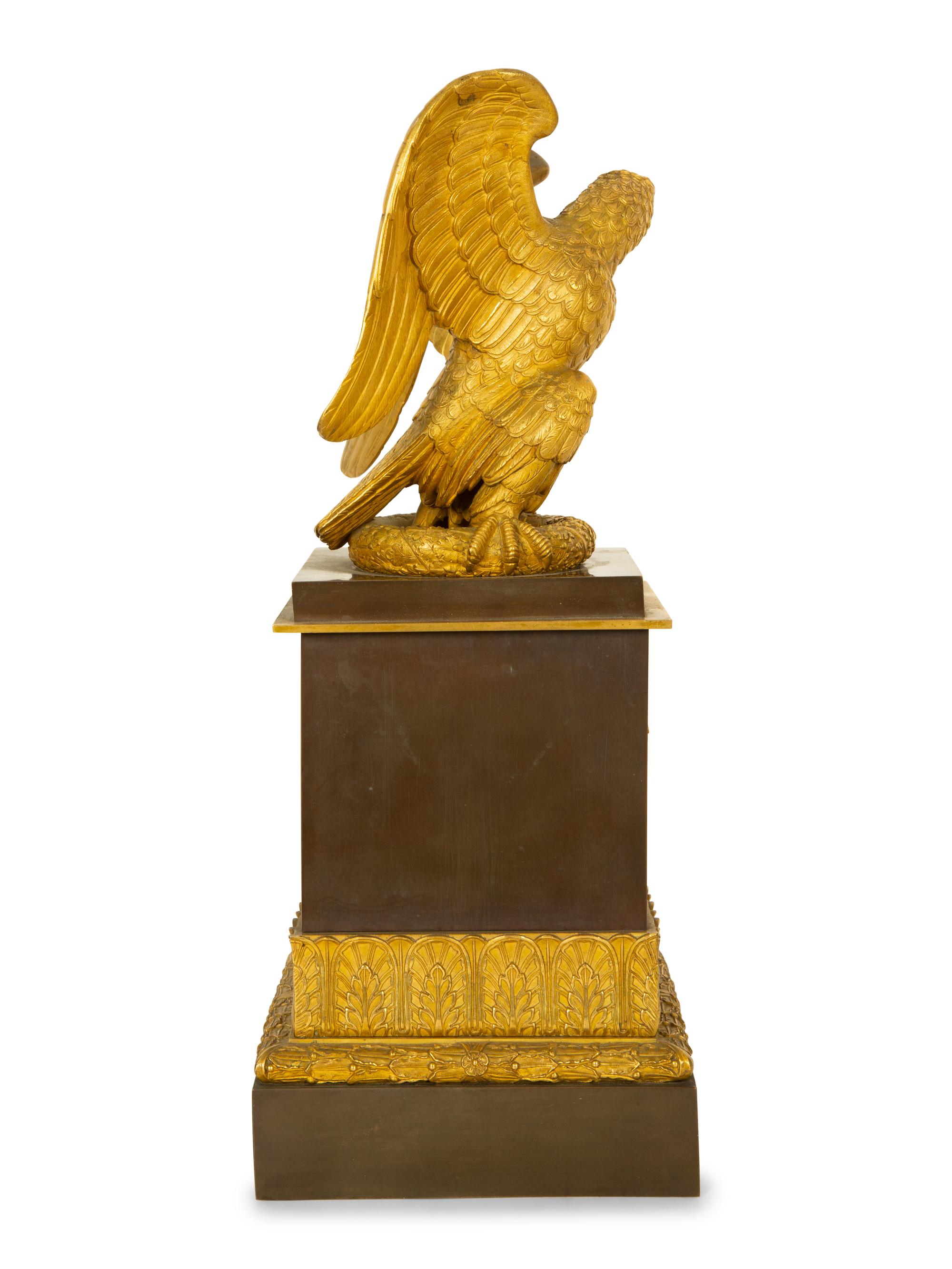 A Gilt Bronze Eagle Sculpture on an Empire Style Gilt and Patinated Bronze Base