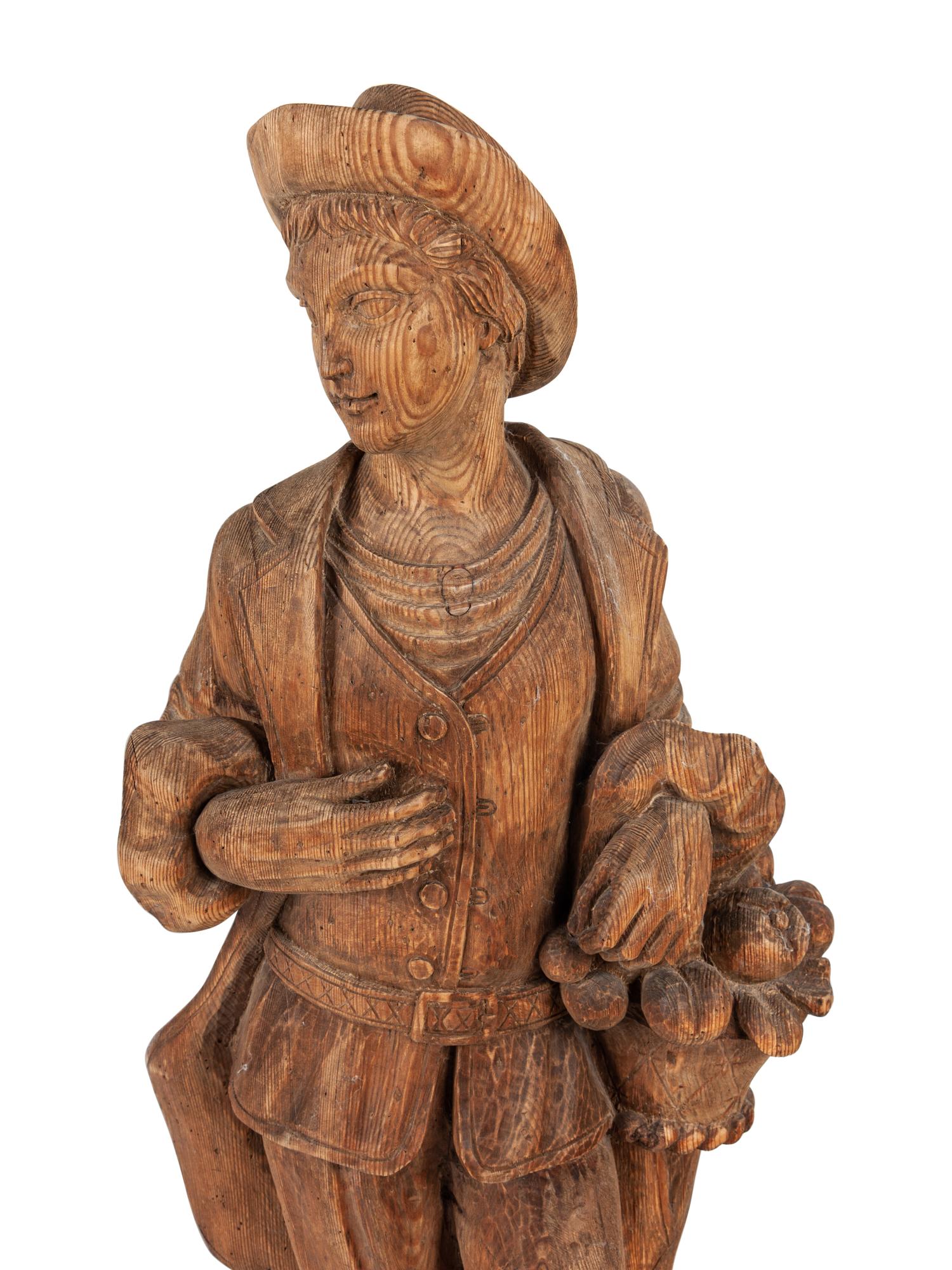 A Pair of Continental Carved Pine Figures