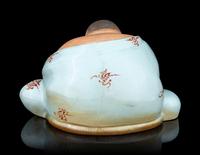 A Celadon Glazed Porcelain Figure of a Budai Buddha
