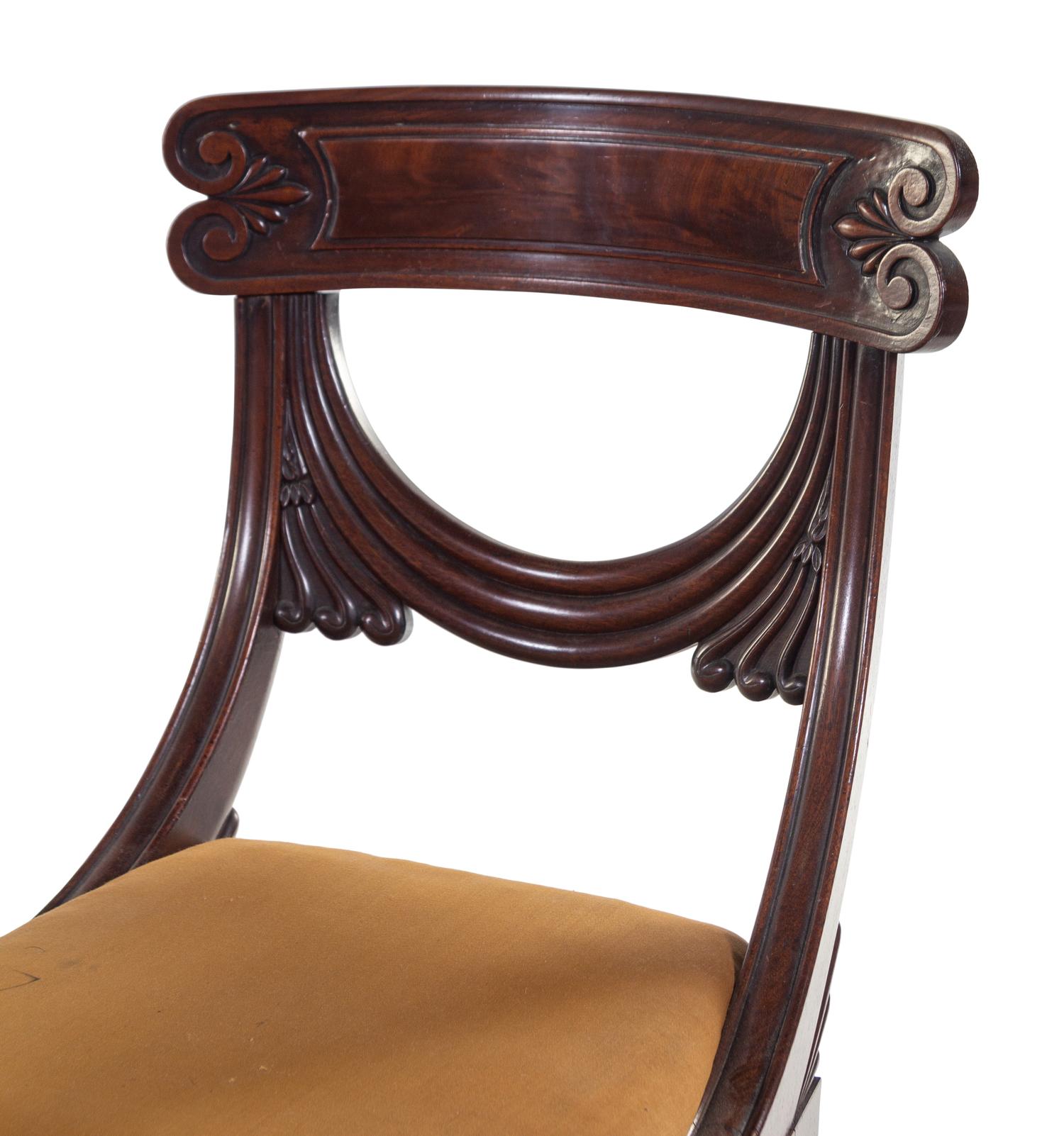A Pair of Late Regency Carved and Figured Mahogany Side Chairs