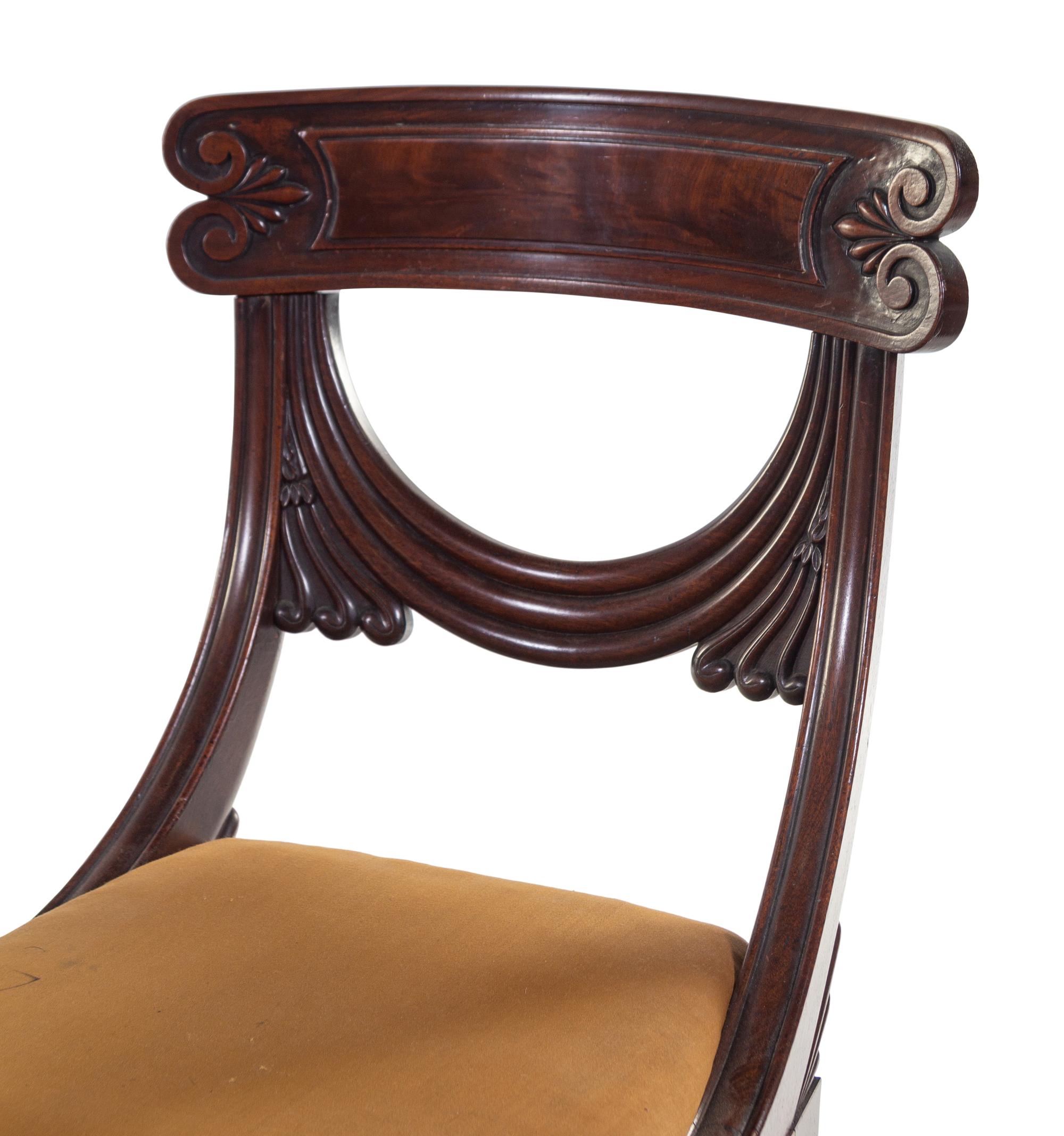 A Pair of Late Regency Carved and Figured Mahogany Side Chairs