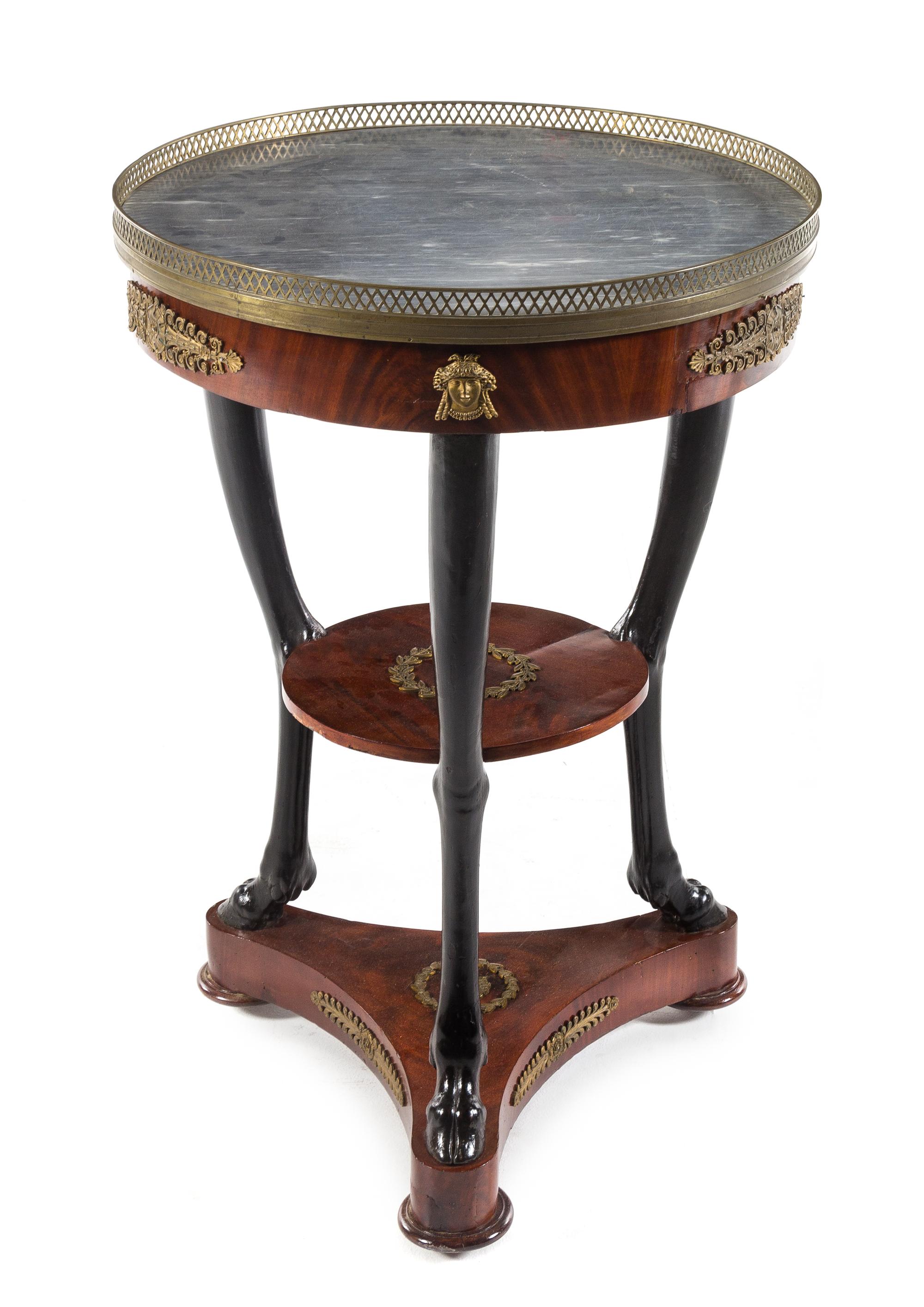 An Empire Gilt Bronze Mounted Parcel Ebonized Gueridon Height 34 1/2 inches. — 19TH CENTURY