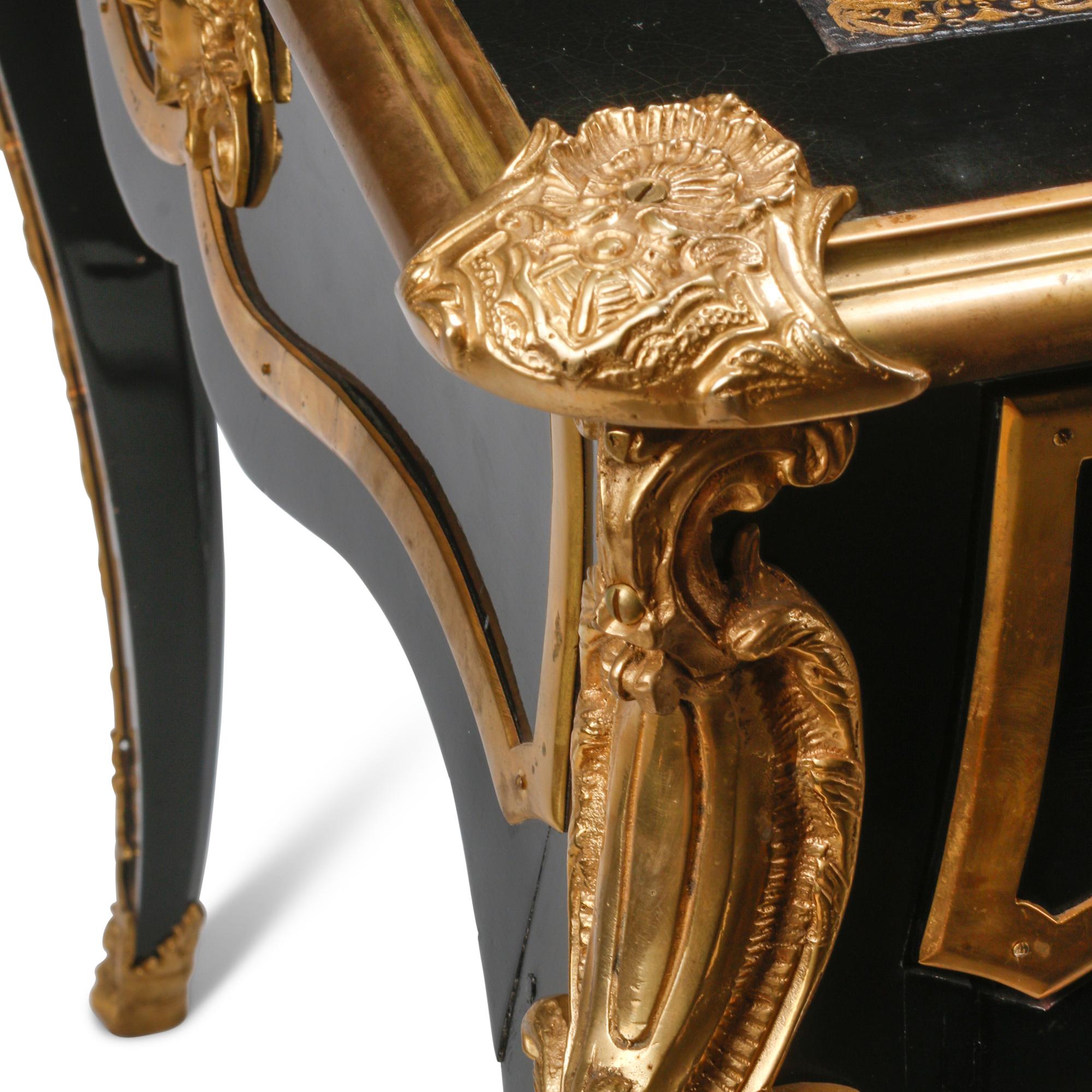 A Louis XV Style Ebonized and Gilt Bronze Mounted Bureau Plat
