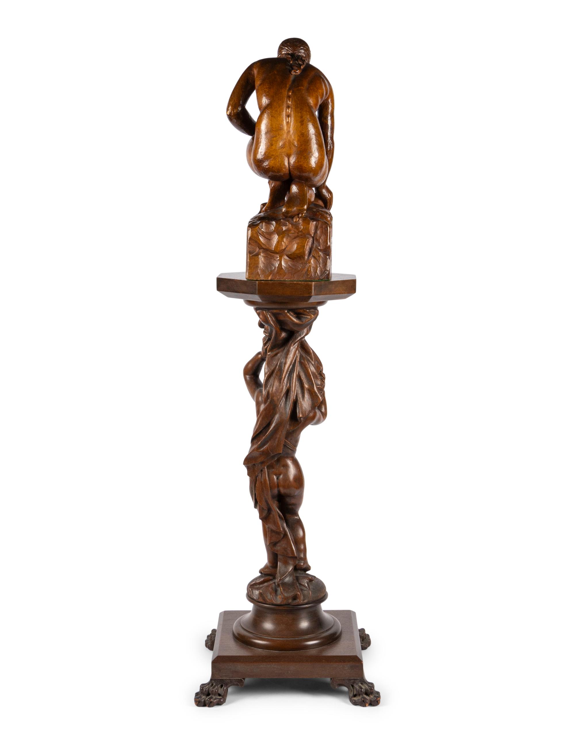 A Carved Wood Sculpture and a Venetian Style Carved Walnut Pedestal