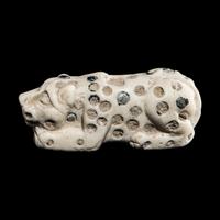 A Mesopotamian Marble and Lapis Lazuli Inlay Recumbent Feline