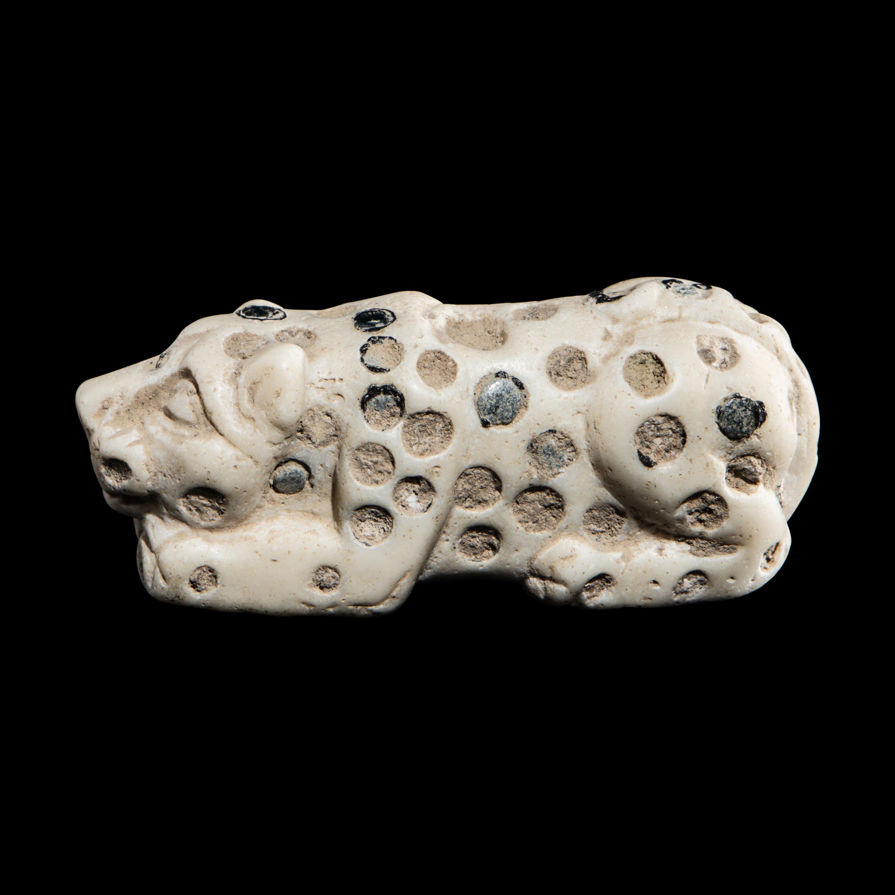 A Mesopotamian Marble and Lapis Lazuli Inlay Recumbent Feline