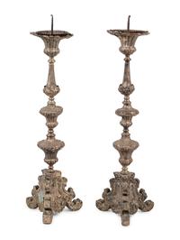 A Pair of Baroque Repoussé Decorated Silvered Metal Pricket Sticks