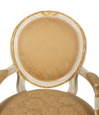 A Set of Eight Louis XVI Style Painted and Parcel Gilt Fauteuils