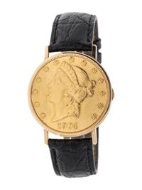 BAUME & MERCIER, YELLOW GOLD HIDDEN DIAL COIN WATCH