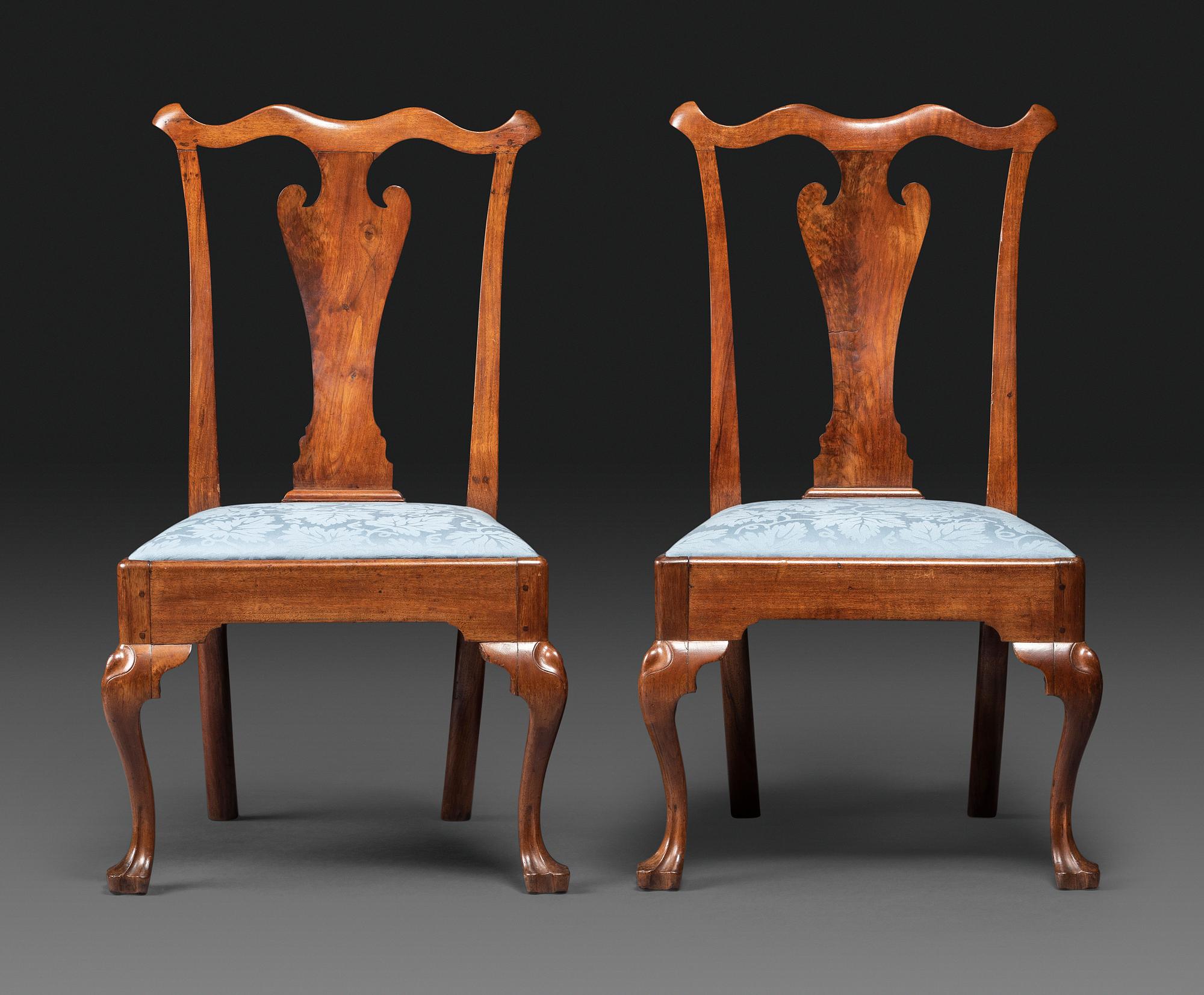 A Pair of Queen Anne Carved Walnut Trifid Foot Side Chairs
