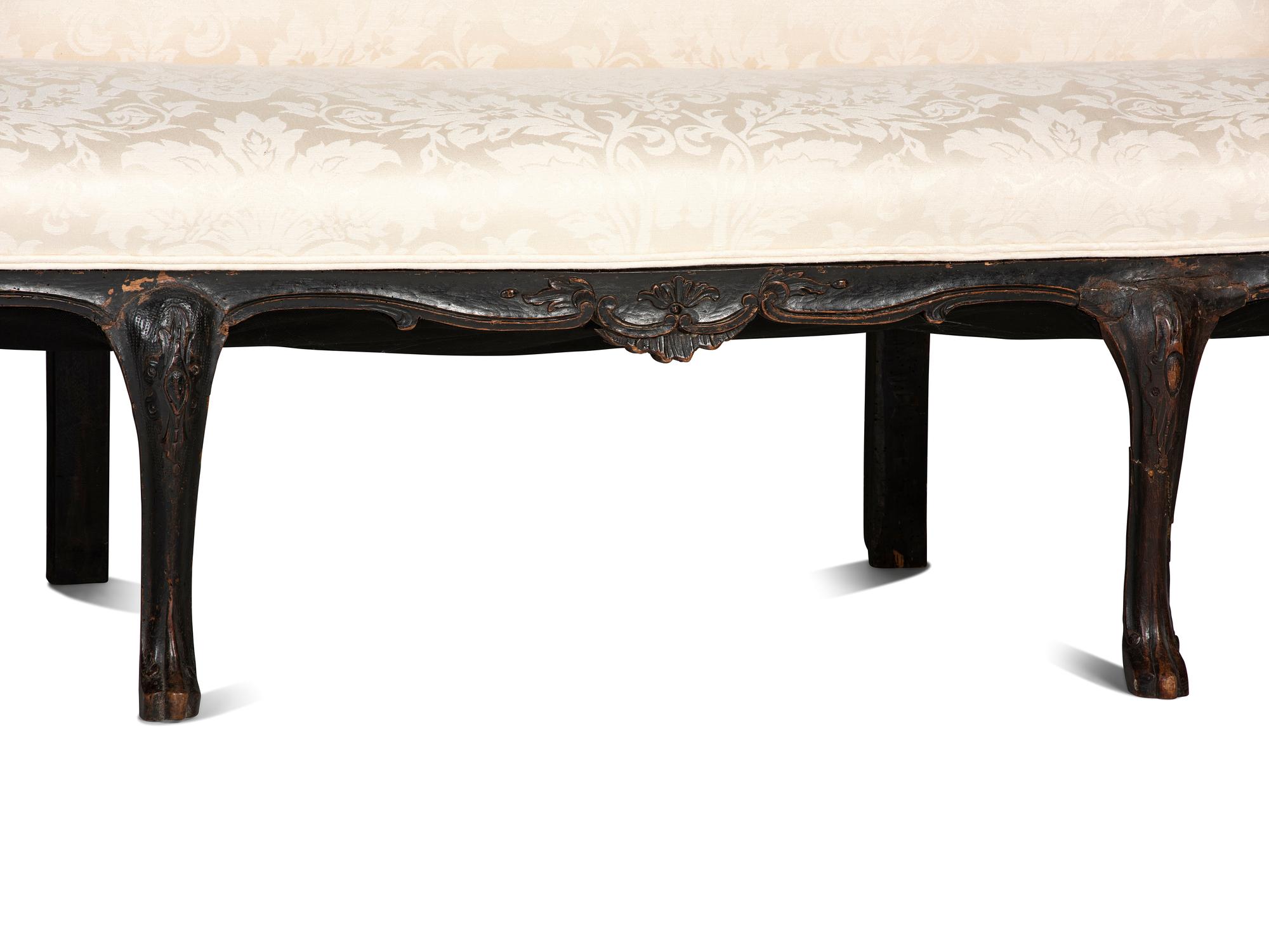 An Italian Carved and Black Painted Walnut High-Back Sofa
