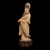 A Chinese carved beige soapstone figure of Guanyin and carved hardwood stand 壽山石雕觀音配木座 Late Qing dynasty/Republic period ?????