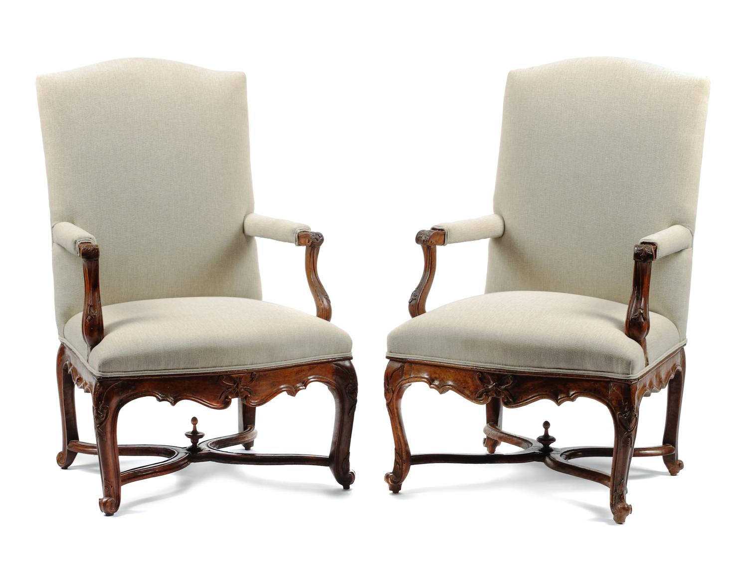A Pair of Louis XV Style Carved Walnut Fauteuils