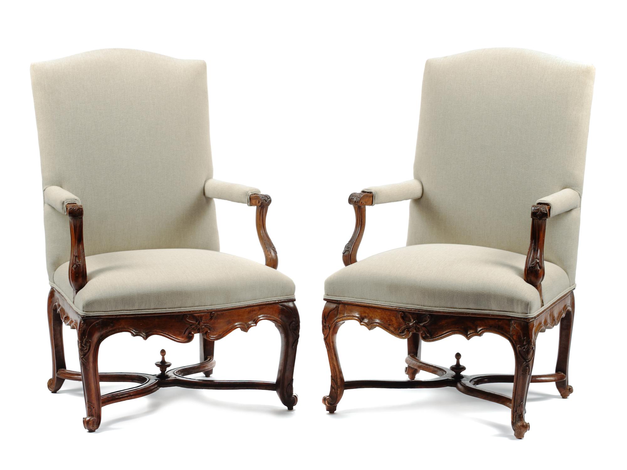 A Pair of Louis XV Style Carved Walnut Fauteuils