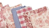 A Group of Red Toile Table Linens