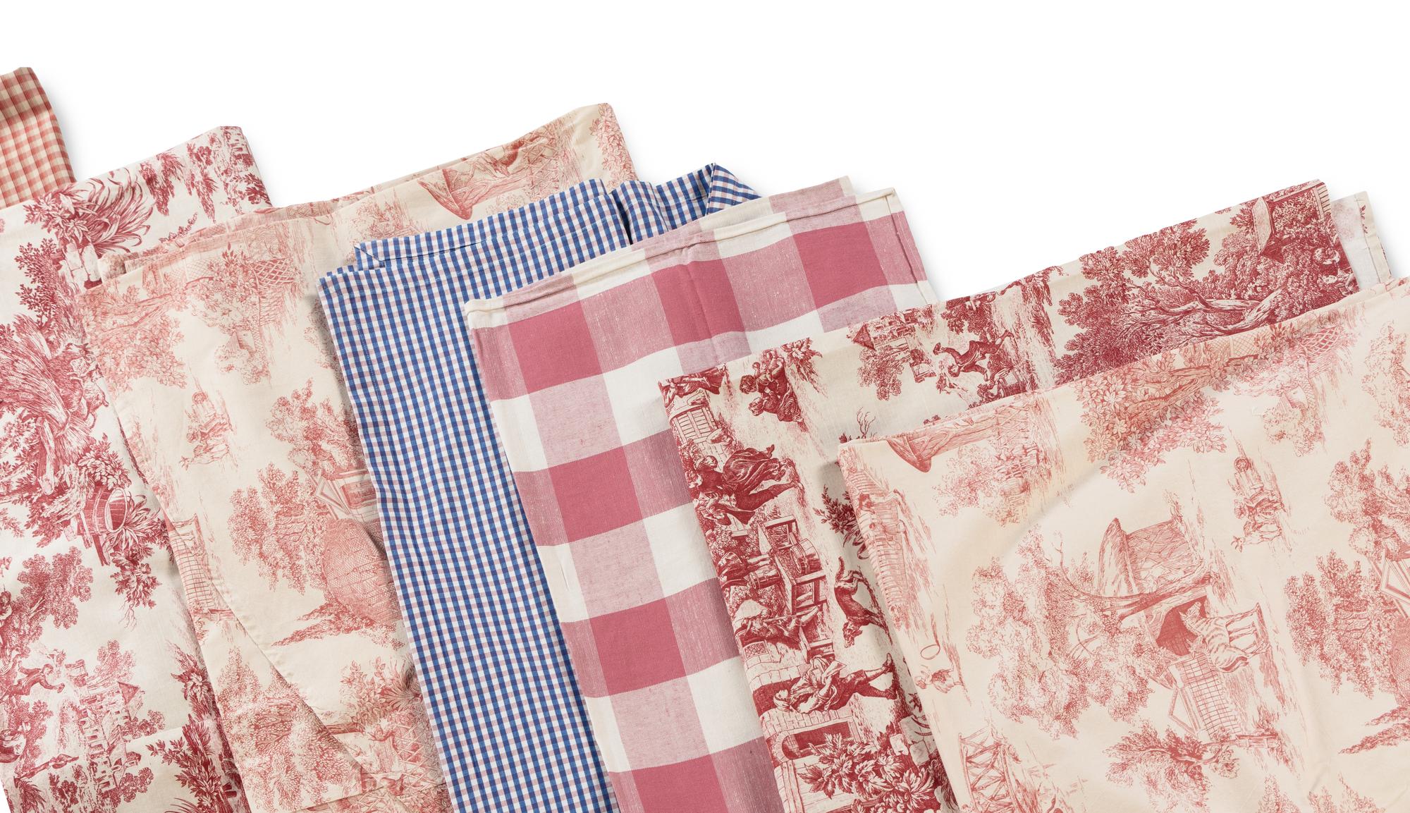 A Group of Red Toile Table Linens